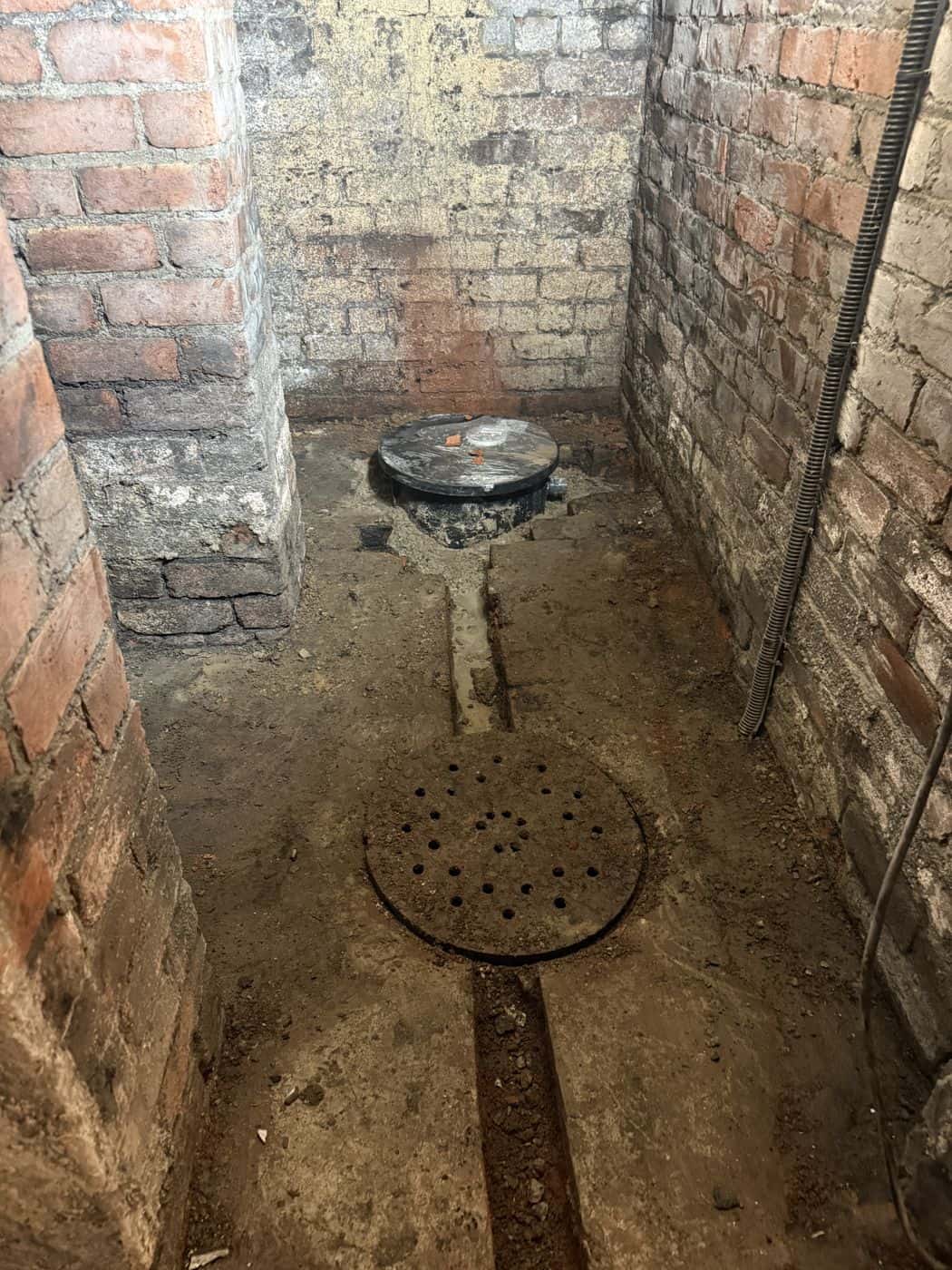 Failed builder's sump and debris before works began