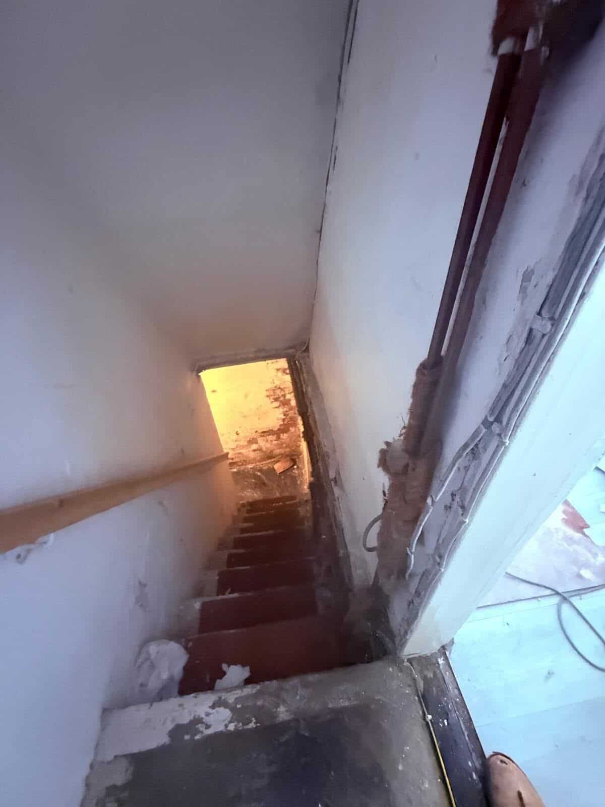 Original cellar steps in a Barnsley terrace with the adjacent wall stripped back during damp works