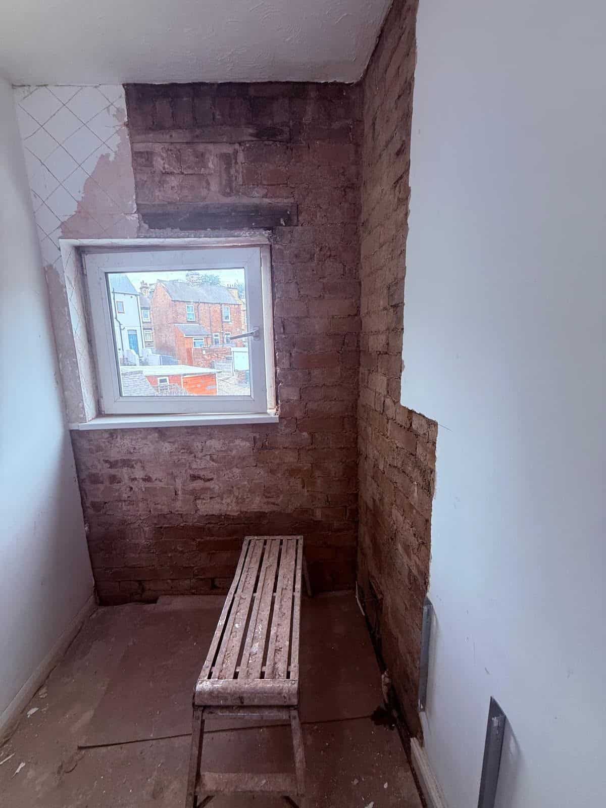 Rear bedroom wall taken back to bare brick and prepared before the damp system was installed