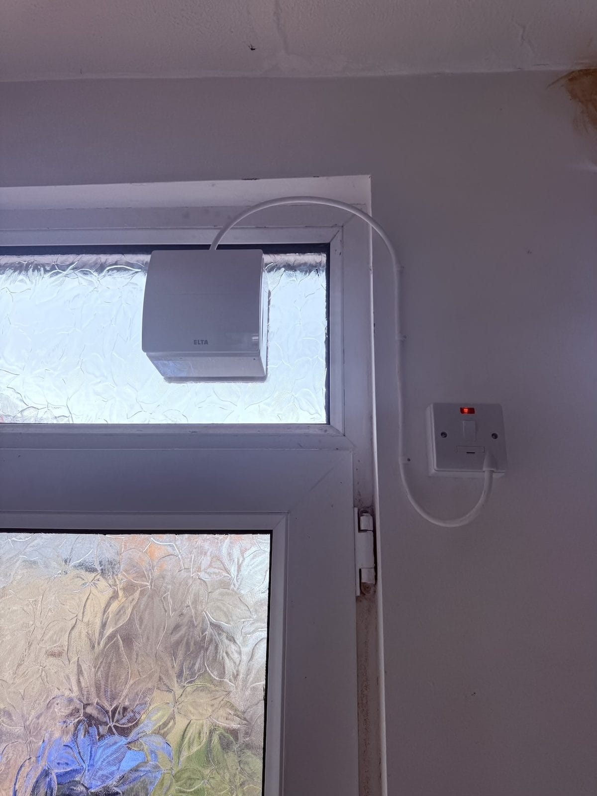 Completed Elta DEXA dMEV 100 fan in a Barnsley door light, wired to a dedicated fused spur with the neon lit