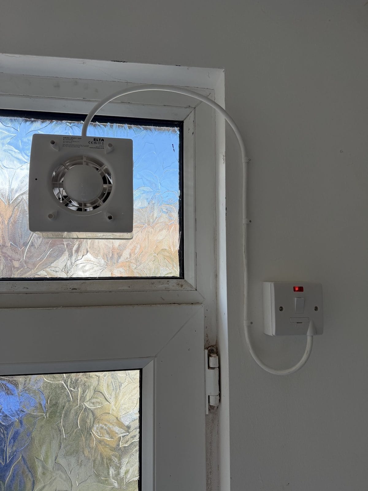 Elta DEXA dMEV 100 fan body fitted through the door light glass with the fascia cover removed