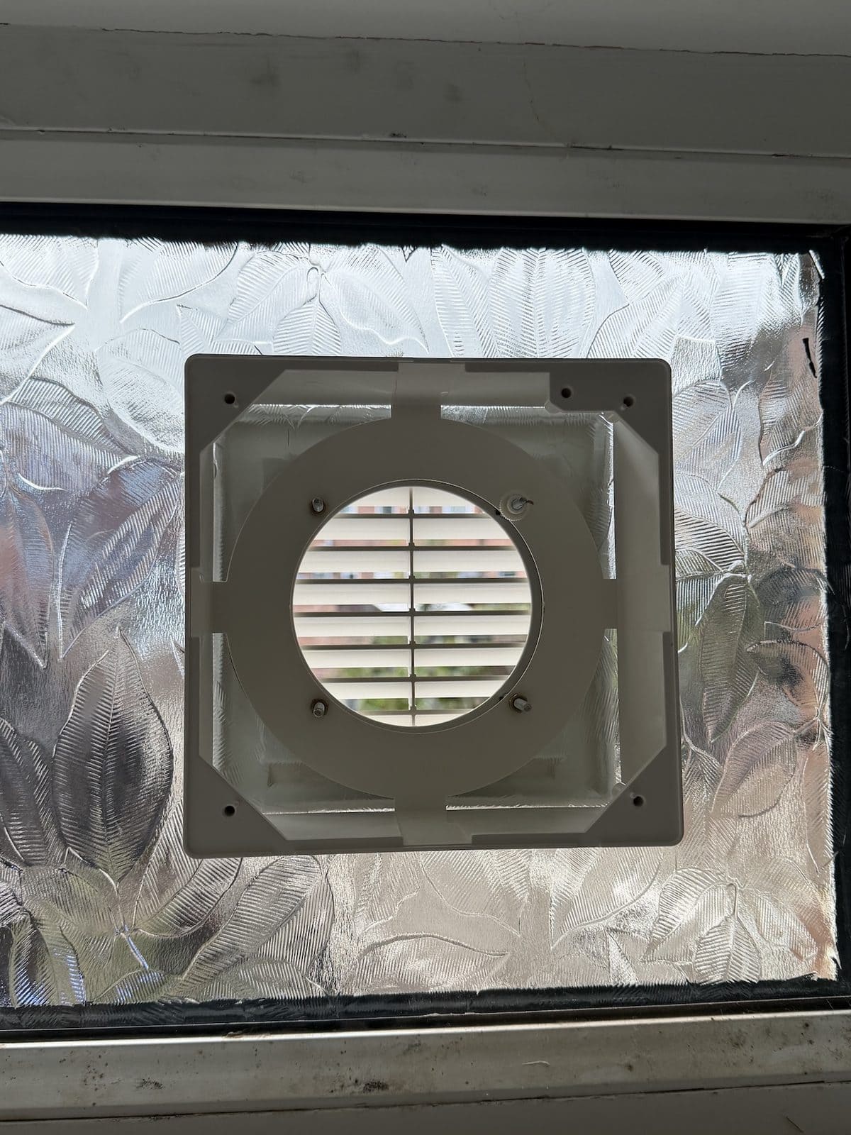 Elta window kit with fixed external grille seated through patterned frosted glass in a door light