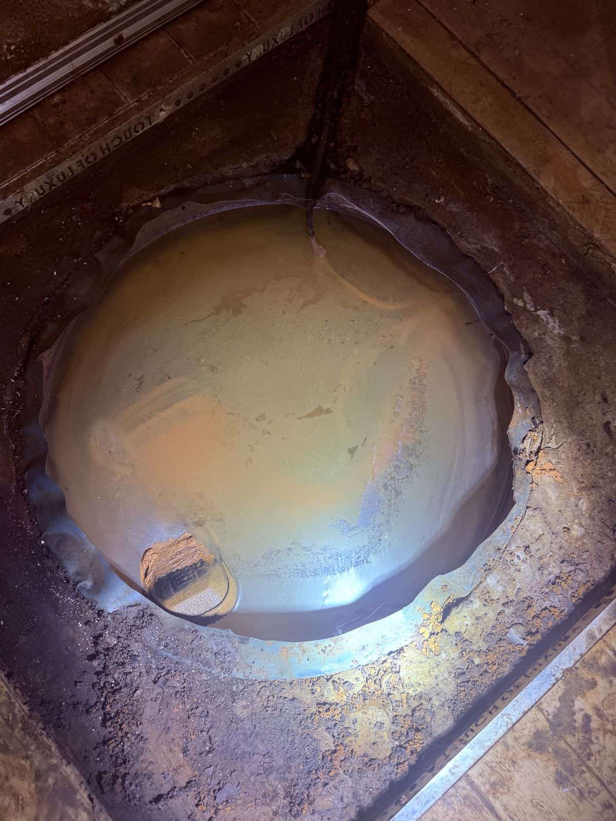 Silted sump chamber in a Leeds cellar before the new waterproofing system was specified