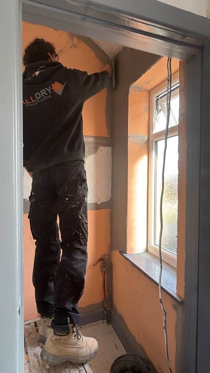 All Dry operative fitting the Isotherm thermal lining to a prepared wall